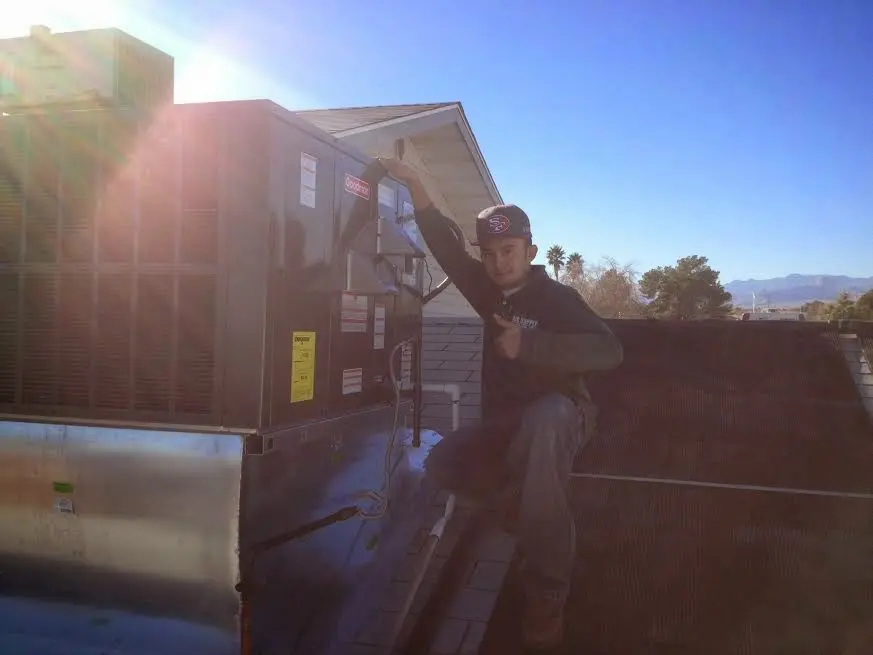 HVAC technician performing HVAC Inspection on a rooftop unit in Buena Vista